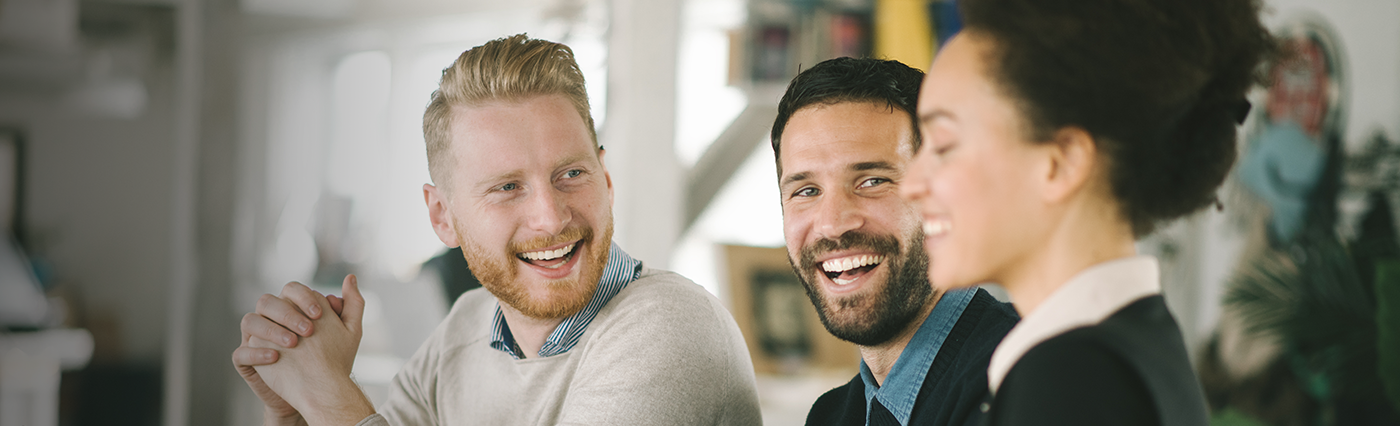 Two men smiling for a picture while wearing shirts and ties.